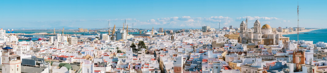 Aerial panoramic view of the old city rooftops and Cathedral de Santa Cruz in the afternoon from tower Tavira in Cadiz, Andalusia, Spain