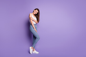 Full length photo of attractive young woman fingers shoulder copyspace wear white singlet isolated on violet color background
