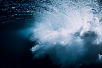 Breaking wave with foam and bubbles underwater. Transparent water