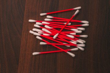 Cotton swabs isolated on a wooden background