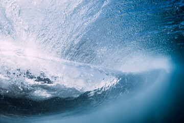 Breaking wave with foam and bubbles underwater. Transparent water