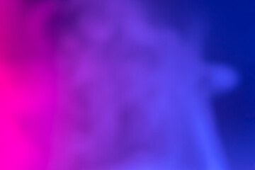 Pink and blue smoke on blurred dark background.Abstract foggy background.