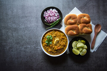 Indian street food pao bhaji or bread and masala curry along with salad condiments. 