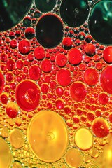 Colorful and sparkling oil droplets on water surface