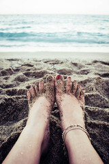 feet in the sand on the beach