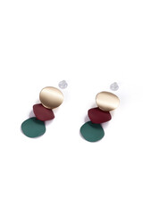 Subject shot of two earrings with pendants. Each earring is made as curved golden disc with hanging burgundy and green petals. The pair of earrings is isolated on the white backdrop.