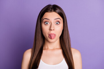 Photo of funny young woman wear casual white outfit showing tongue big eyes isolated violet color background