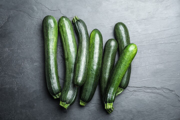 Green ripe zucchinis on black slate table, flat lay