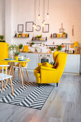 Trendy fashion luxury interior design in Scandinavian style of studio apartment with bright yellow furniture and decorated with new year lights.
