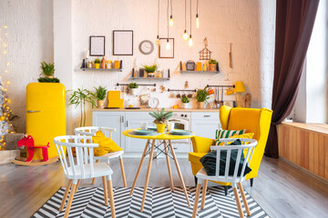 Trendy fashion luxury interior design in Scandinavian style of studio apartment with bright yellow furniture and decorated with new year lights.