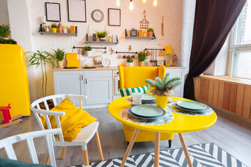 Trendy fashion luxury interior design in Scandinavian style of studio apartment with bright yellow furniture and decorated with new year lights.