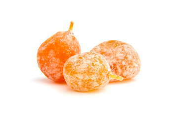 Candied fruits, three dried kumquats isolated on white background