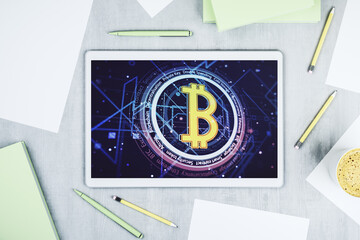 Top view of modern digital tablet screen with creative Bitcoin symbol hologram. Mining and blockchain concept. 3D Rendering