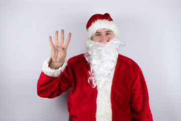 Fototapeta na wymiar Man dressed as Santa Claus standing over isolated white background showing and pointing up with fingers number four while smiling confident and happy