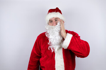 Man dressed as Santa Claus standing over isolated white background touching mouth with hand with painful expression because of toothache or dental illness on teeth