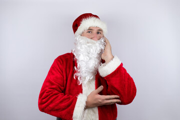 Man dressed as Santa Claus standing over isolated white background thinking looking tired and bored with crossed arms