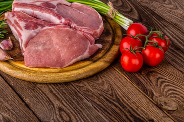 fresh raw new-york steak on wooden Board on wooden background with salt and pepper in a rustic style.