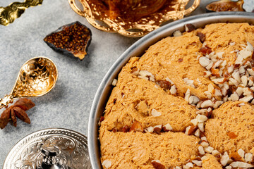 Turkish pastries and scattered dry fruits on table