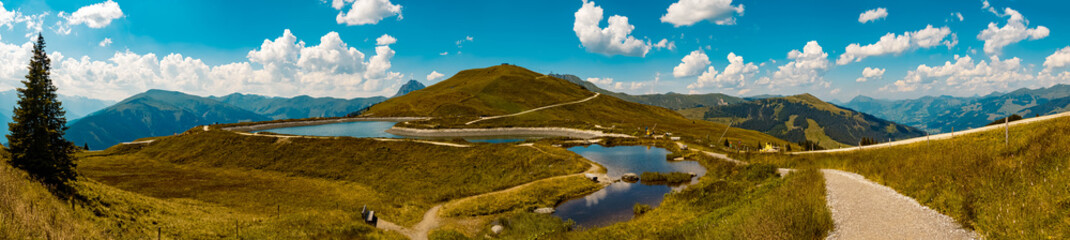 Fototapeta premium High resolution stitched panorama of a beautiful alpine view at the famous Panoramabahn Kitzbueheler Alpen, Salzburg, Austria