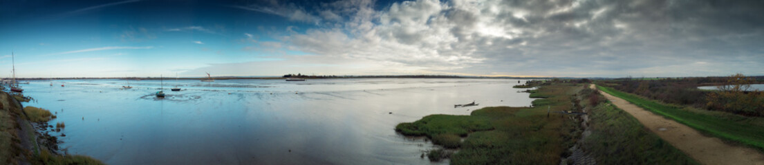 panoramic landscape image of mudflat in essex england