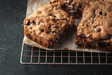 Apple pie on the black background. Homemade fresh pie on baking paper