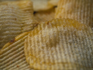 Ready-to-eat potato chips and oily food or junk food.Textured background