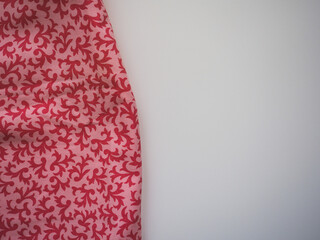 Red and pink kitchen towel from close up with white background. Copy space
