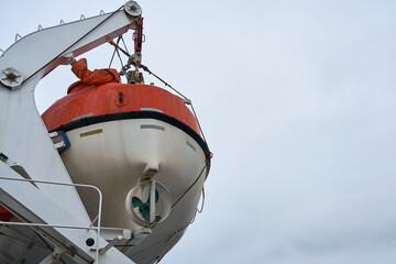 A lifeboat against a cloudy sky. Copy space.    