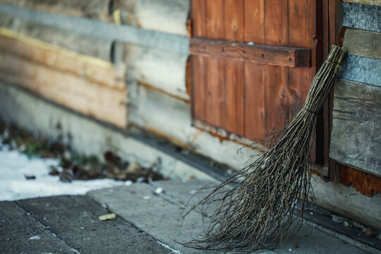 A broomstick stands near the door of a rural house in Siberia, Russia.
