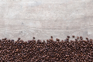 coffee beans on wooden floor background. top view