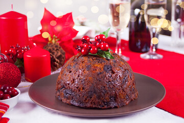 Fototapeta na wymiar Traditional Christmas pudding with holly on top.
