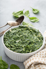 Creamed spinach with garlic in a white bowl