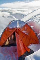 Tent above the clouds. View from the slope of Marble Wall Peak, Central Tian Shan, Kazakhstan - China.