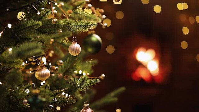Christmas Tree with Decorations and Gifts Near a Fireplace with Lights