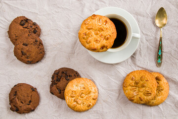 Cup of black espresso coffee and cookies on the white cloth background, sweet pastry dessert