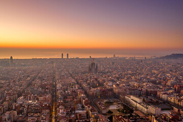 Aerial drone shot of Barcelona city before sunrise golden hour