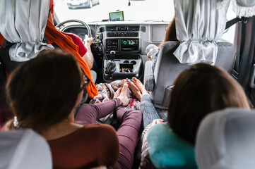 People go on vacation. Friends car trip to the mountains. Passenger POV at summer day on a country road, having fun driving the empty highway on tour journey.