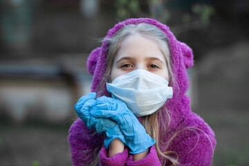 Blond girl posing in medical face mask and latex protective gloves. New normal. Protection and prevention covid 19. Selective focus.