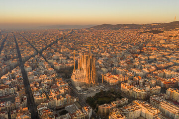 Aerial drone shot of Barcelona city before sunrise golden hour