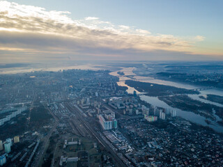 Naklejka na ściany i meble Aerial high flight over Kiev, haze over the city. Autumn morning, the Dnieper River is visible on the horizon.