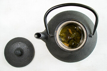 Herbal tea, iron teapot and cup, chinese traditional tea serving