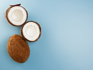 Coconuts on a blue background - top view