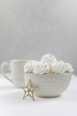Fresh airy handmade vanilla marshmallows in a vase against a light background. New Year's decor