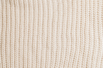 Woolen knitted patterned fabric with folds background texture textile.