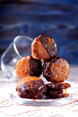 Pile of chocolate marshmallows on a white and blue wooden background