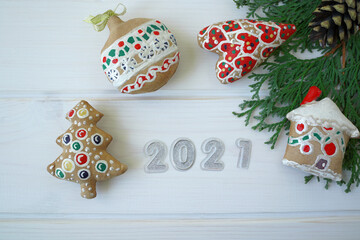 christmas gingerbread cookies and 2021 on white wooden background