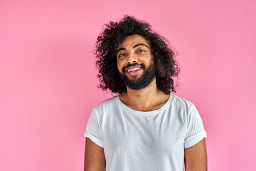 Fototapeta na wymiar pleasant indian arabian male in shirt looking at camera, has friendly look, open-minded guy isolated over pink background