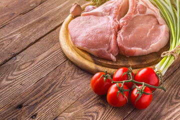 fresh raw new-york steak on wooden Board on wooden background with salt and pepper in a rustic style.