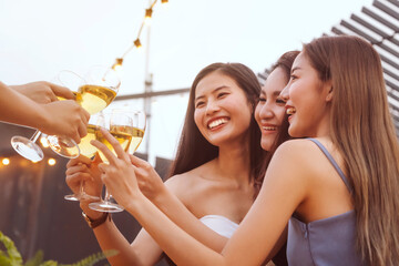 happy asian woman teenagers cheering and toast with white sparkling wine glass to celebrating at...