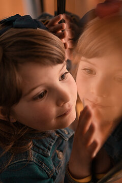 Young Girl Reflecting in Window